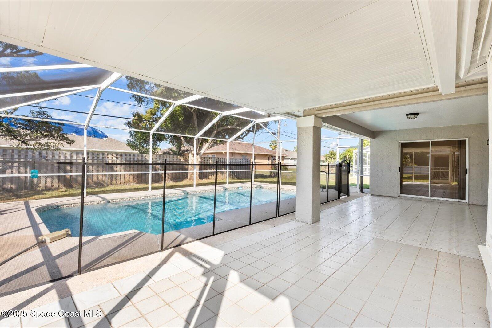 1037 Southwest California Boulevard Port St. Lucie, FL 34953 - Photo 28 of 38 a view of a livingroom with wooden floor and iron fence