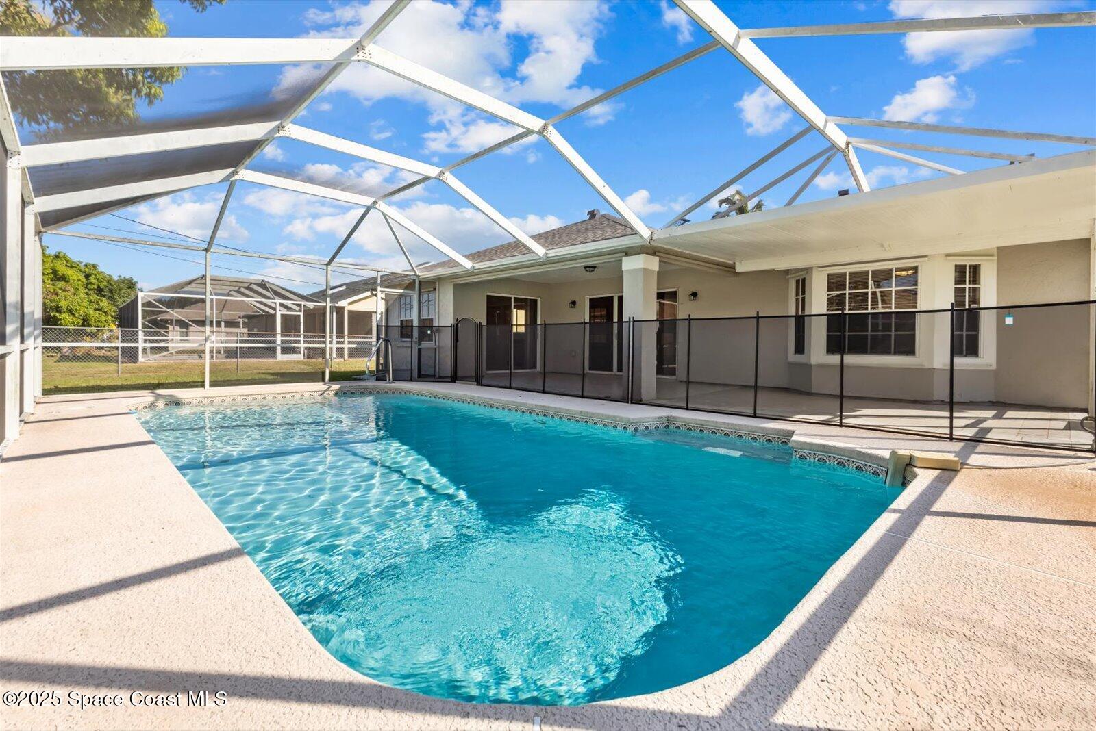 1037 Southwest California Boulevard Port St. Lucie, FL 34953 - Photo 29 of 38 a view of a swimming pool with a patio