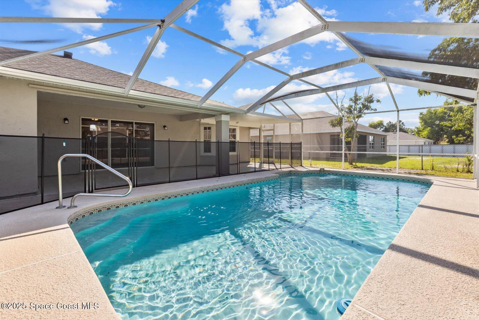 1037 Southwest California Boulevard Port St. Lucie, FL 34953 - Photo 30 of 38 a view of a swimming pool with a patio