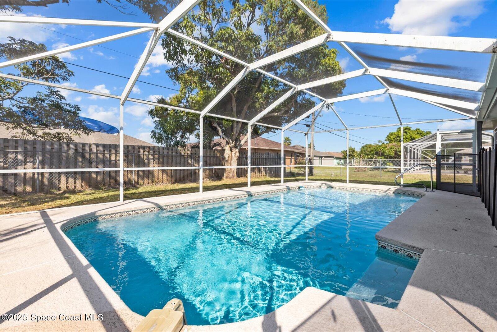 1037 Southwest California Boulevard Port St. Lucie, FL 34953 - Photo 31 of 38 a view of a swimming pool with an outdoor space