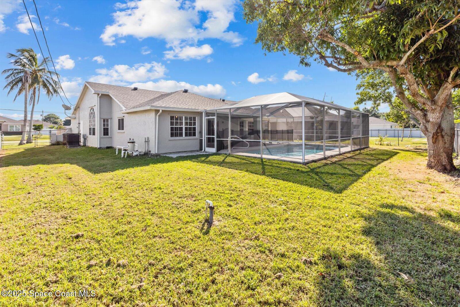 1037 Southwest California Boulevard Port St. Lucie, FL 34953 - Photo 32 of 38 a view of a house with swimming pool and sitting area