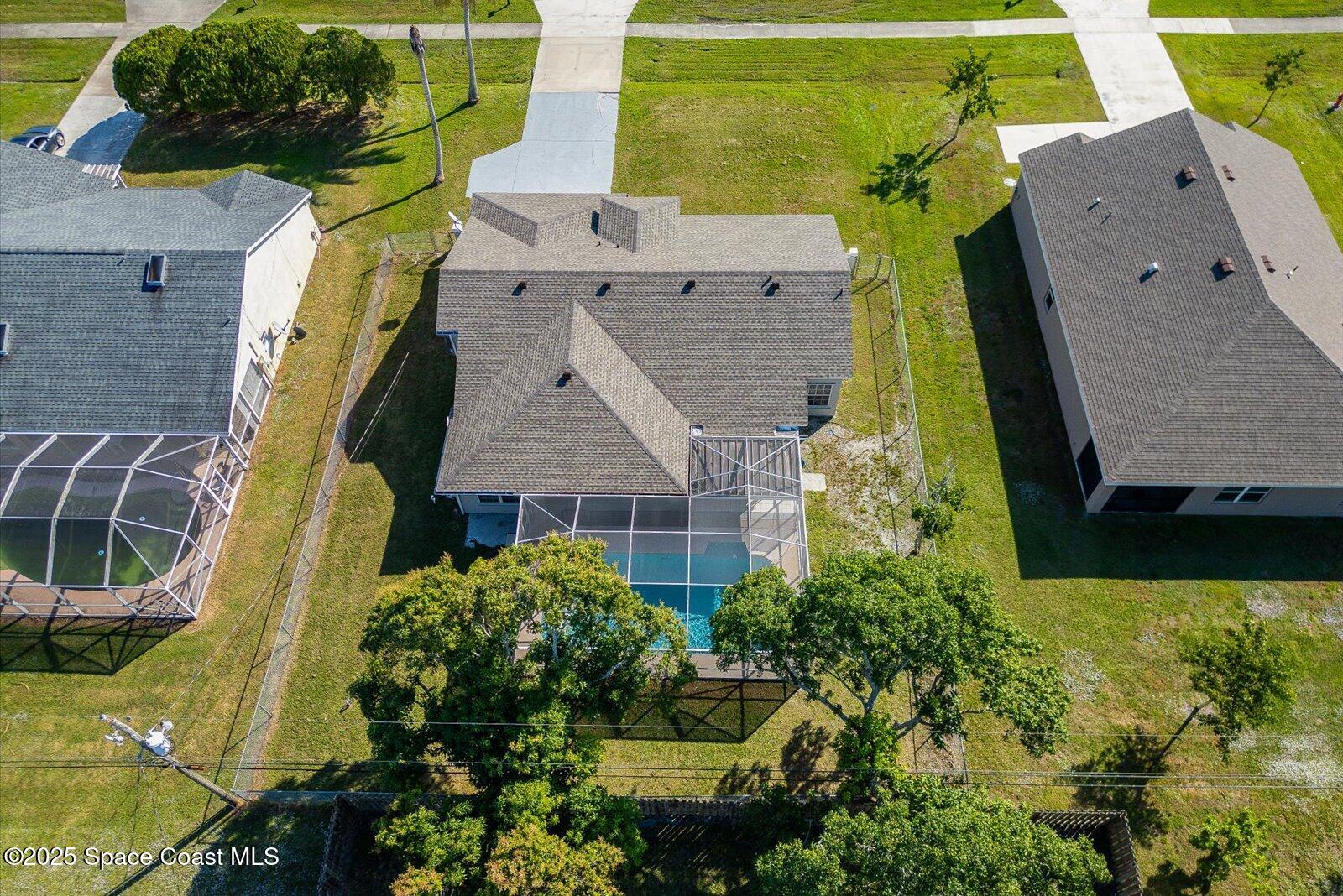 1037 Southwest California Boulevard Port St. Lucie, FL 34953 - Photo 34 of 38 an aerial view of residential houses with outdoor space