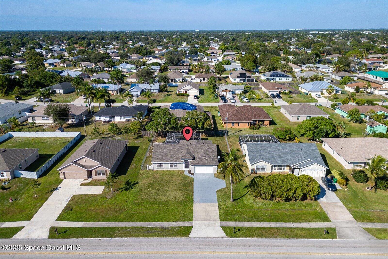 1037 Southwest California Boulevard Port St. Lucie, FL 34953 - Photo 36 of 38 an aerial view of residential houses with yard