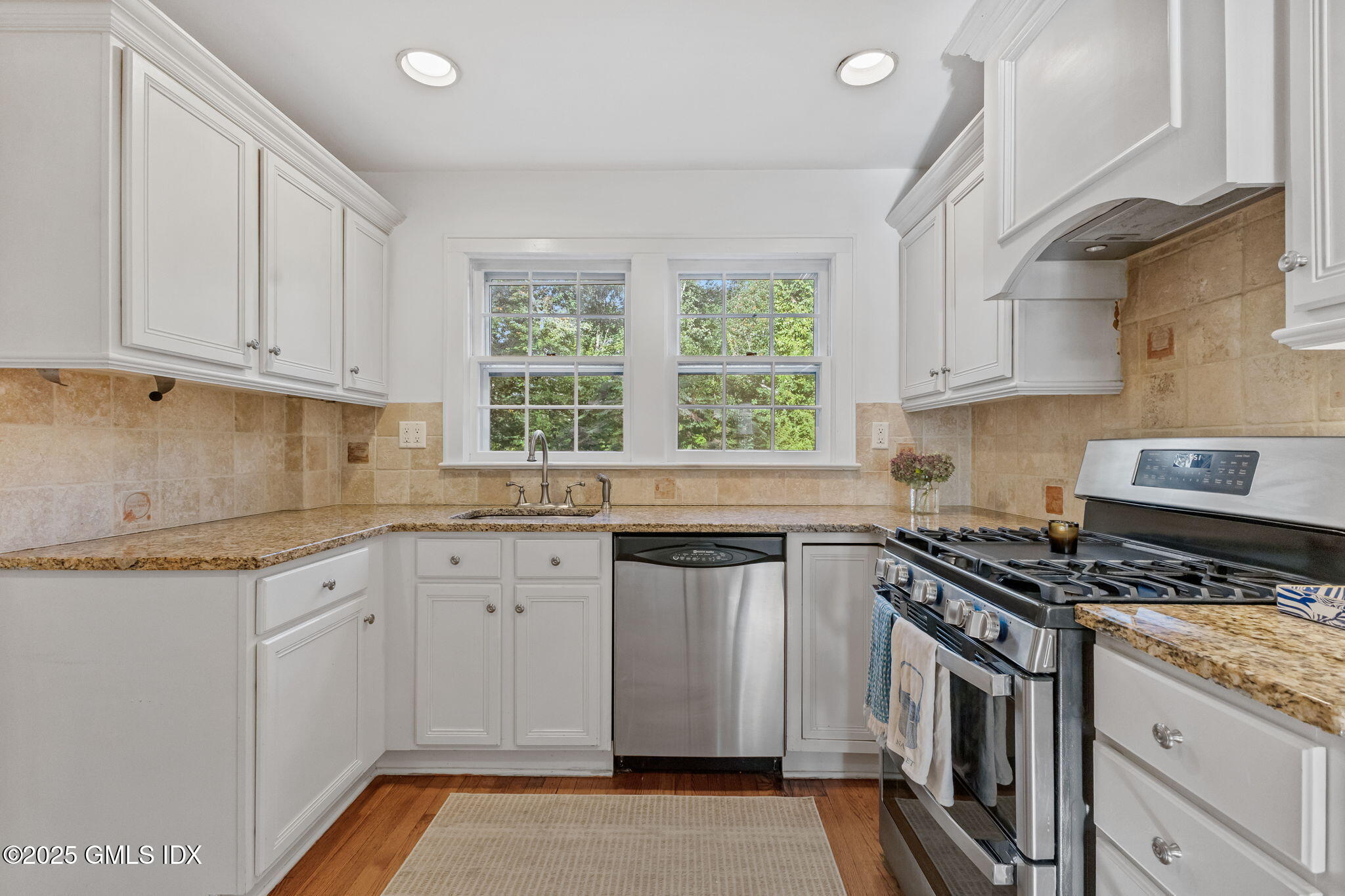 27 Briar Brae Road Stamford, CT 06903 - Photo 12 of 28 a kitchen with granite countertop white cabinets and white appliances