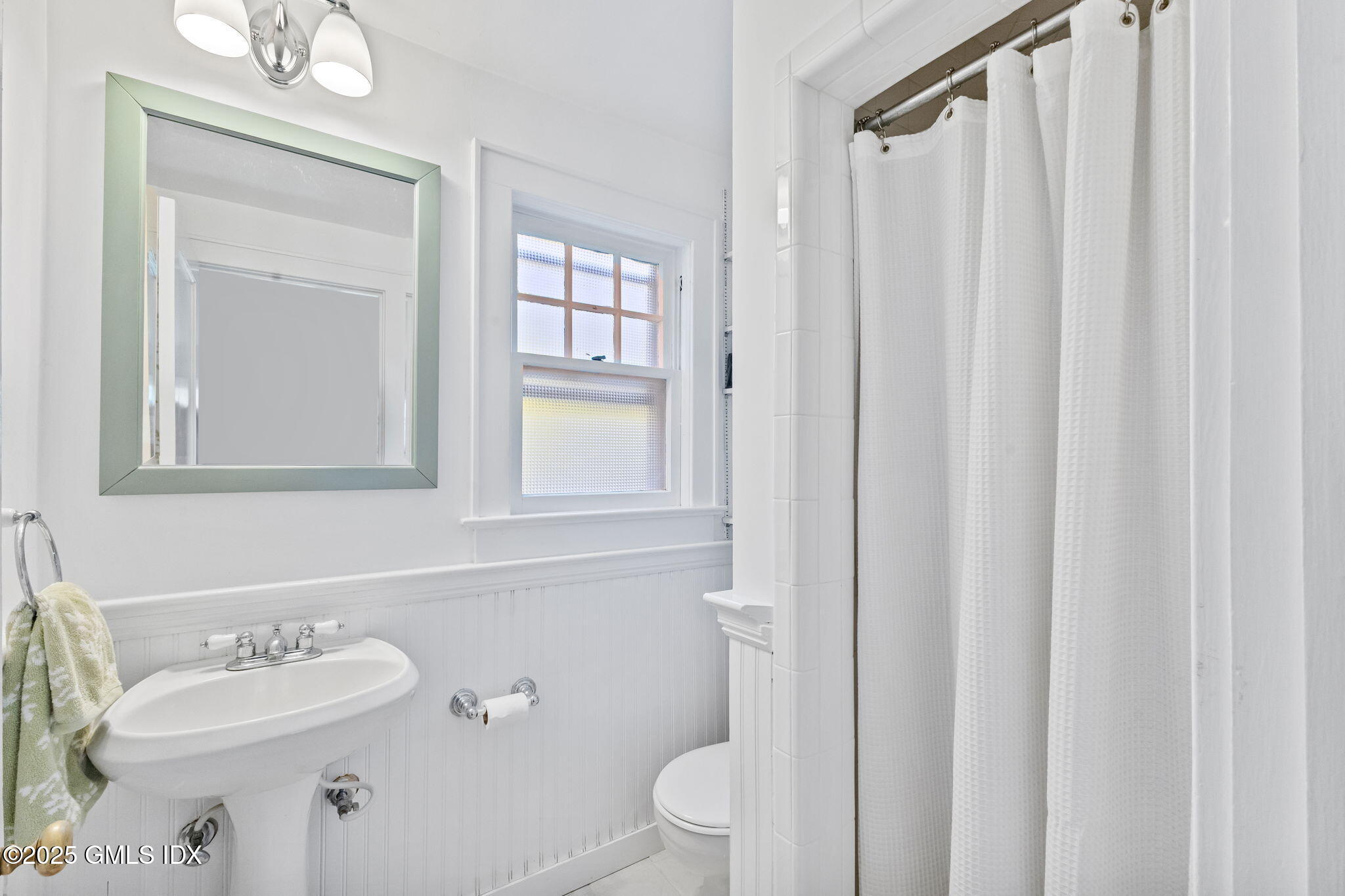 27 Briar Brae Road Stamford, CT 06903 - Photo 16 of 28 a bathroom with a sink a toilet and shower curtain