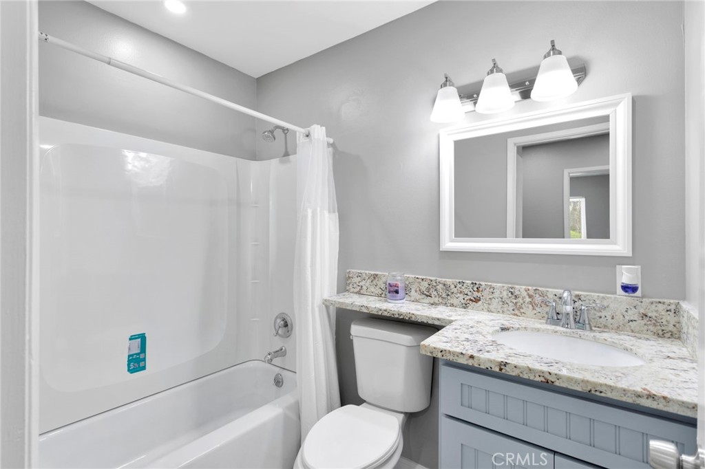 15846 Inyo Street Victorville, CA 92395 - Photo 15 of 44 a bathroom with a granite countertop sink toilet and shower