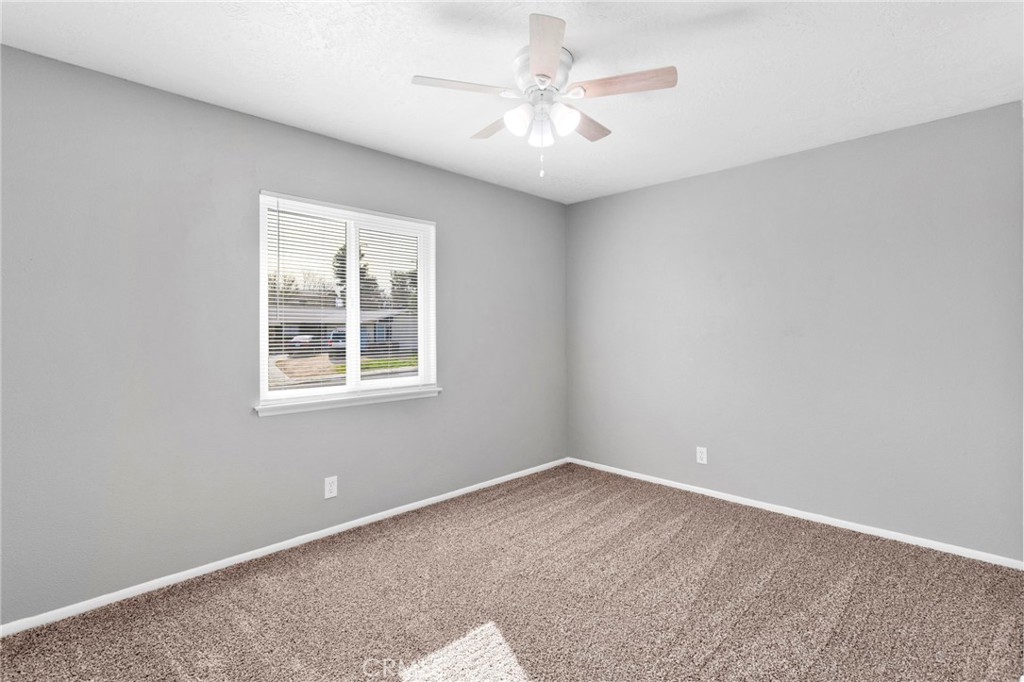 15846 Inyo Street Victorville, CA 92395 - Photo 22 of 44 an empty room with windows and fan