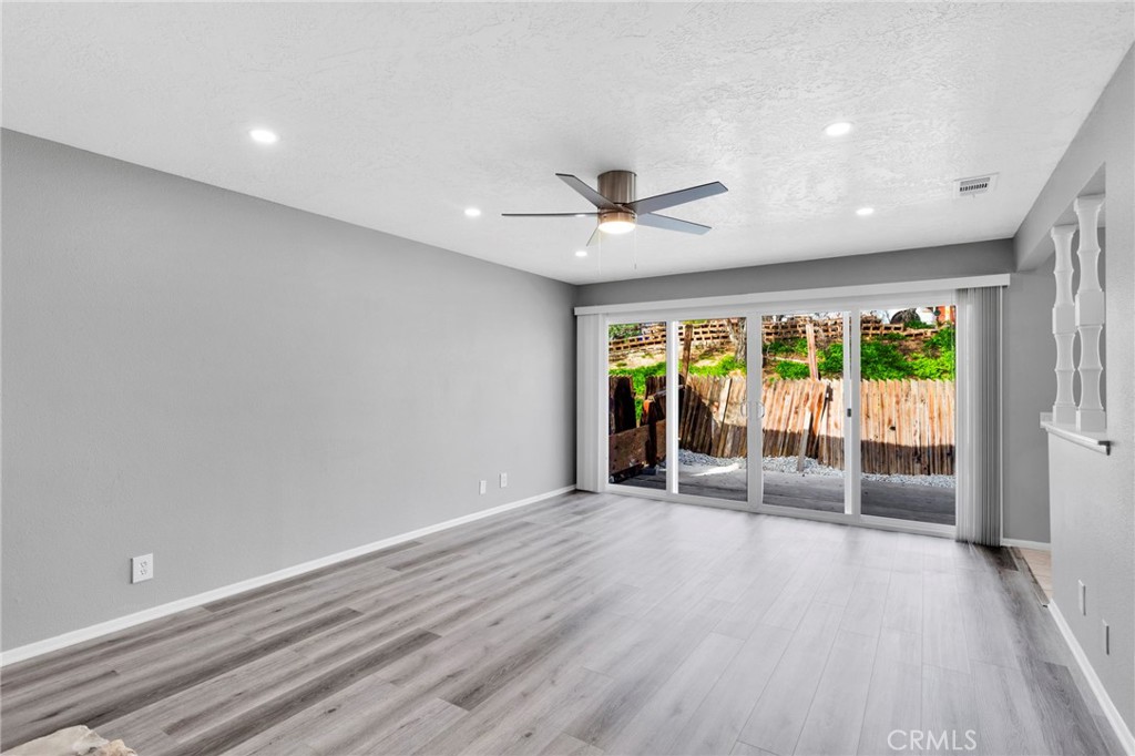 15846 Inyo Street Victorville, CA 92395 - Photo 3 of 44 wooden floor in an empty room with a window