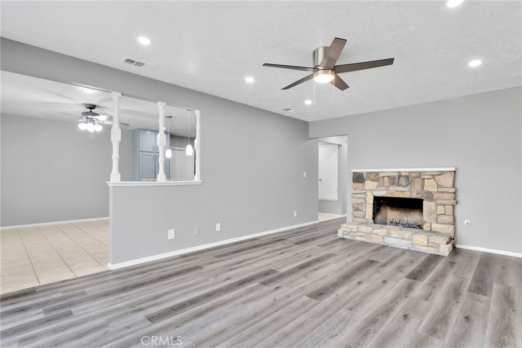 15846 Inyo Street Victorville, CA 92395 - Photo 5 of 44 a view of an empty room with wooden floor fireplace and a window