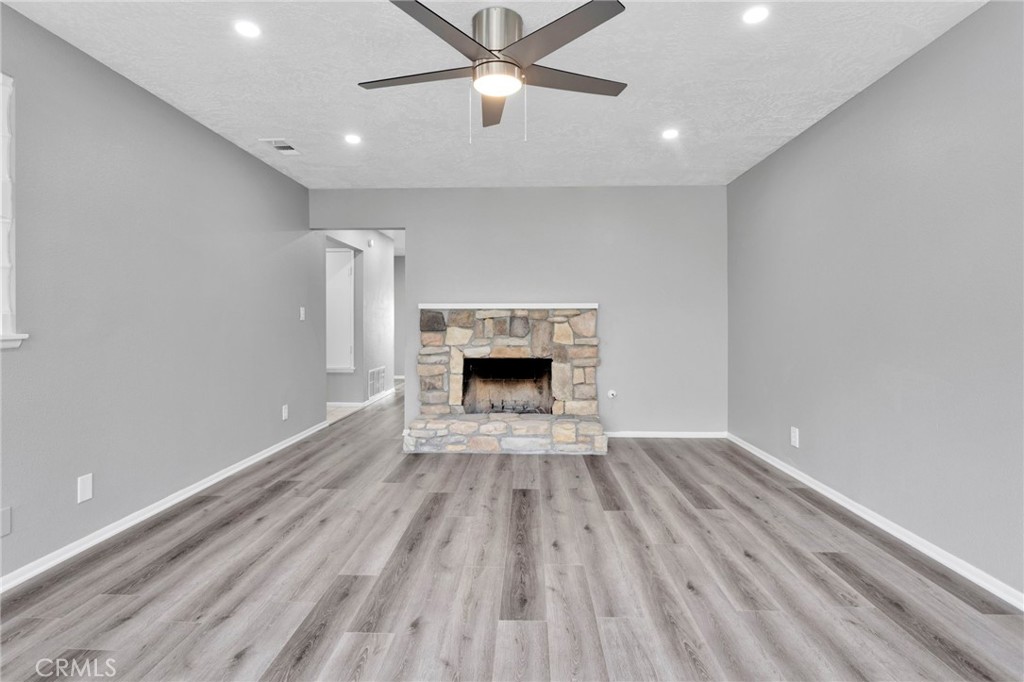 15846 Inyo Street Victorville, CA 92395 - Photo 6 of 44 wooden floor fireplace and window in an empty room