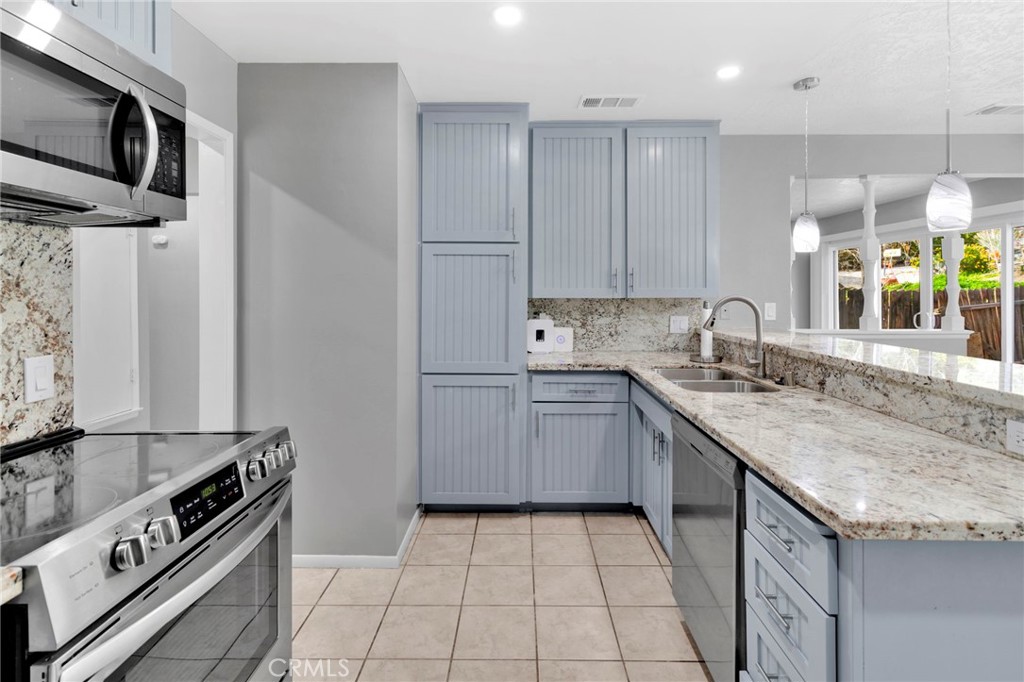 15846 Inyo Street Victorville, CA 92395 - Photo 7 of 44 a kitchen with a sink stove top oven and cabinets
