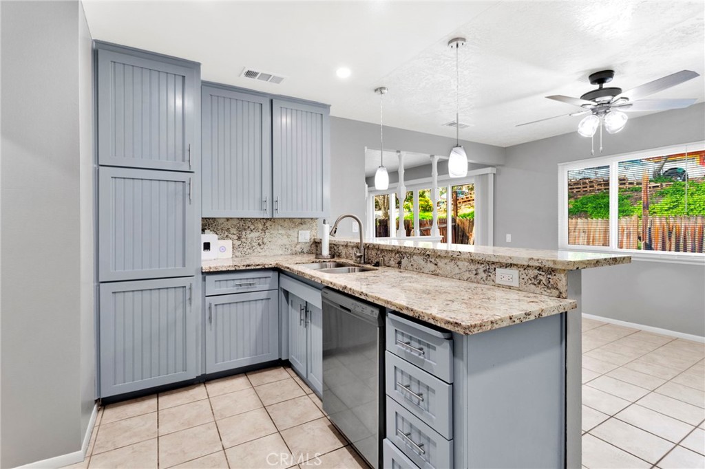 15846 Inyo Street Victorville, CA 92395 - Photo 8 of 44 a kitchen with stainless steel appliances granite countertop a sink stove and cabinets