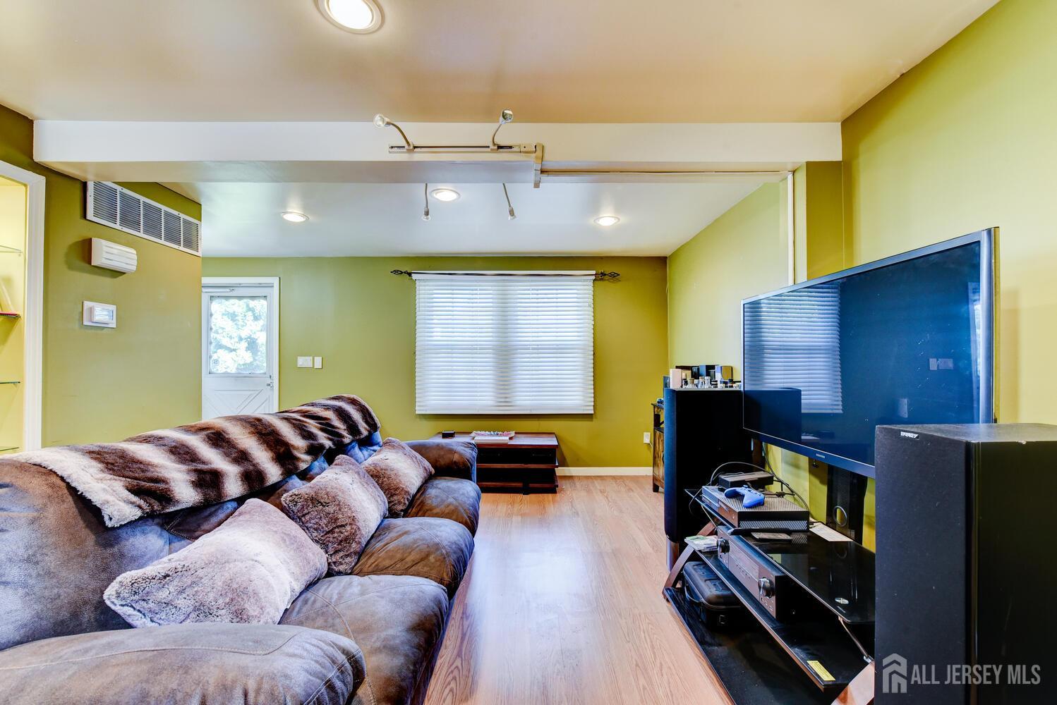 675 Bound Brook Road, Unit C0016 Dunellen, NJ 08812 - Photo 11 of 39 a living room with furniture and a flat screen tv