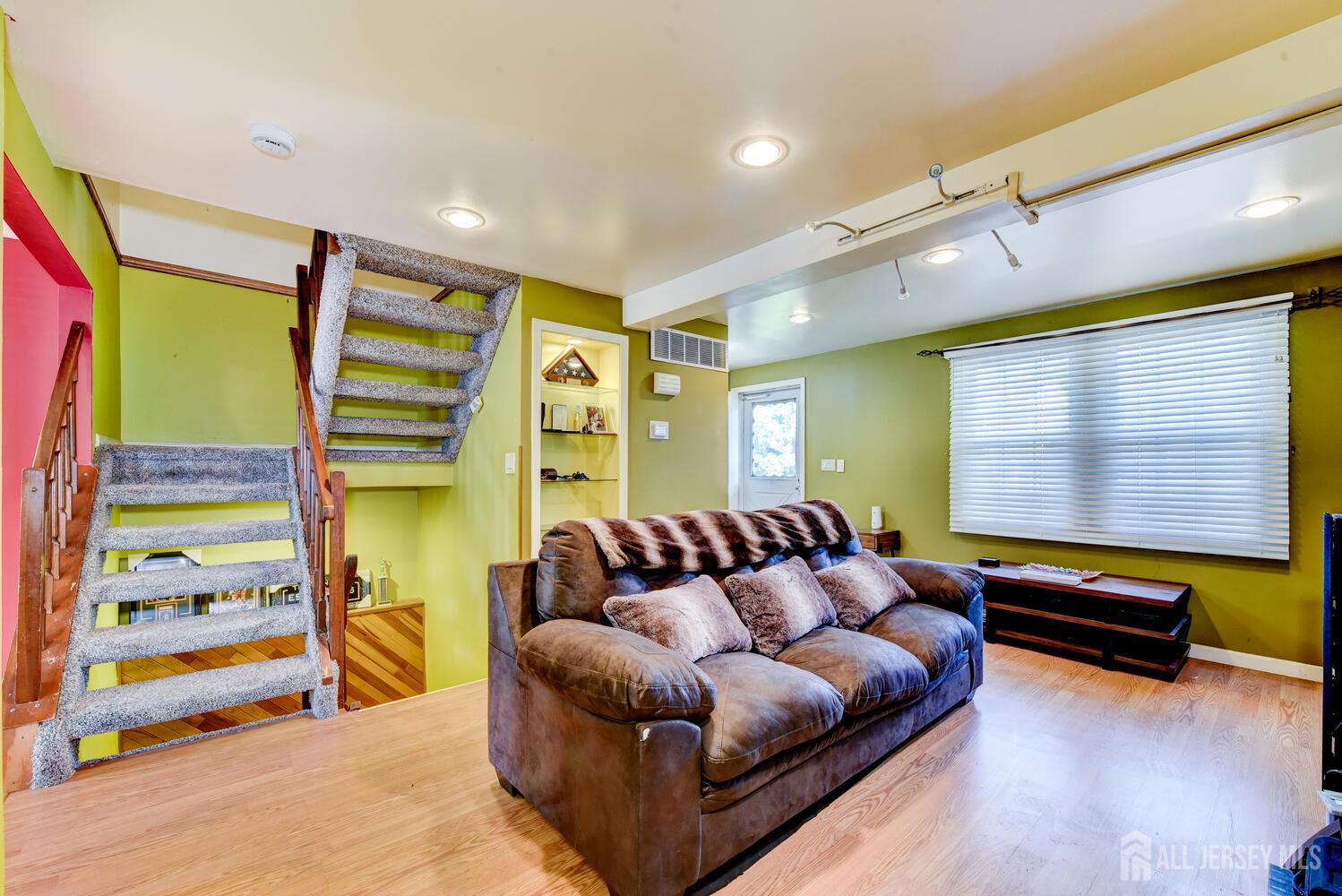 675 Bound Brook Road, Unit C0016 Dunellen, NJ 08812 - Photo 12 of 39 a living room with furniture and a flat screen tv