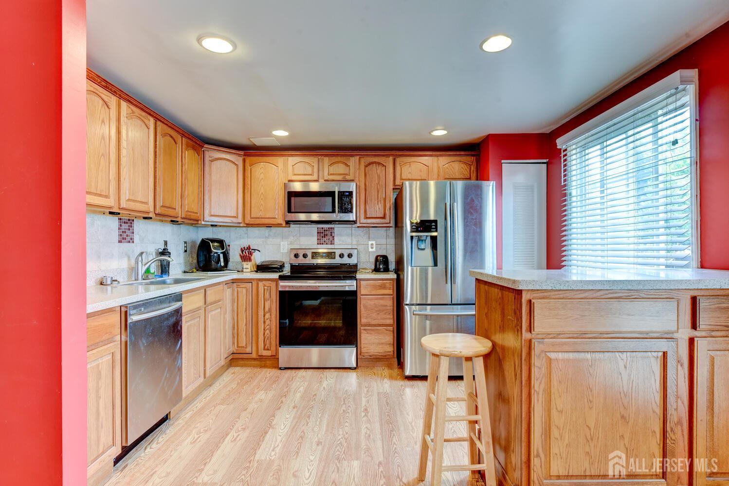 675 Bound Brook Road, Unit C0016 Dunellen, NJ 08812 - Photo 19 of 39 a kitchen with stainless steel appliances granite countertop a refrigerator and a stove top oven