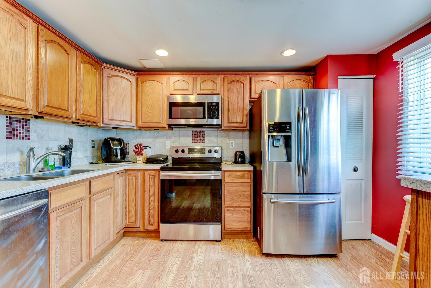 675 Bound Brook Road, Unit C0016 Dunellen, NJ 08812 - Photo 20 of 39 a kitchen with stainless steel appliances granite countertop a refrigerator microwave and sink