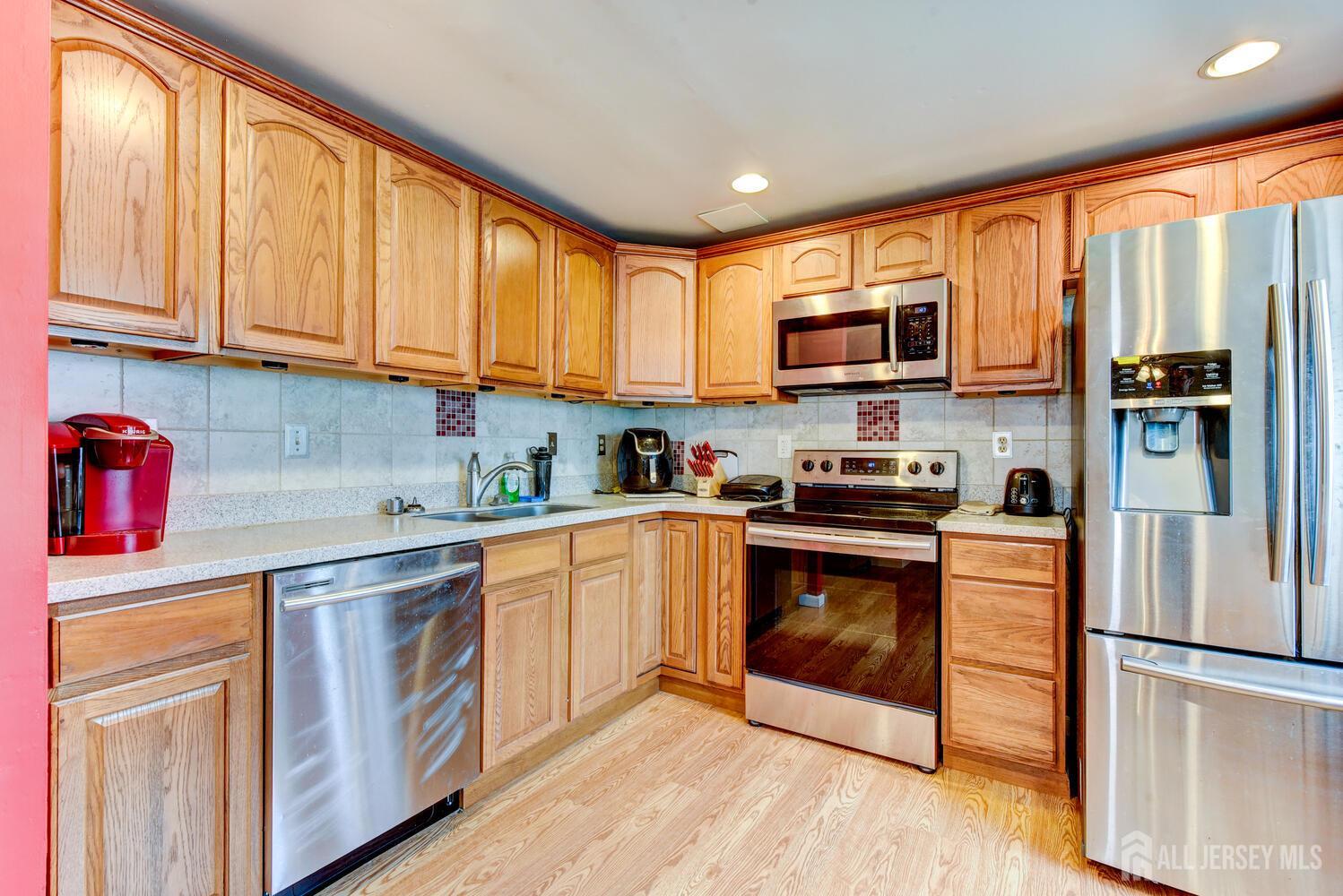 675 Bound Brook Road, Unit C0016 Dunellen, NJ 08812 - Photo 21 of 39 a kitchen with stainless steel appliances granite countertop a refrigerator stove top oven and sink