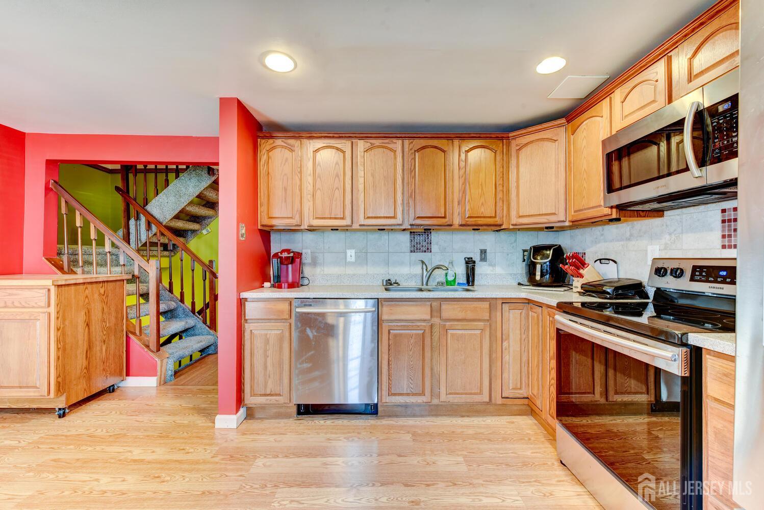 675 Bound Brook Road, Unit C0016 Dunellen, NJ 08812 - Photo 22 of 39 a kitchen with stainless steel appliances granite countertop a stove a sink and a microwave