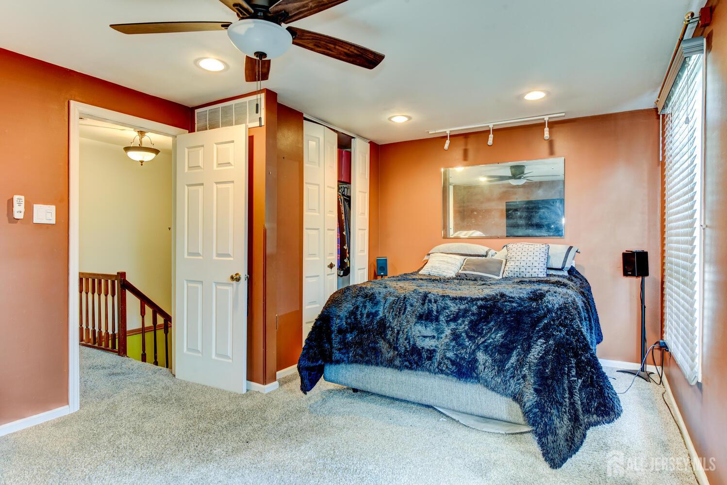 675 Bound Brook Road, Unit C0016 Dunellen, NJ 08812 - Photo 29 of 39 a bedroom with a bed and a walk in closet