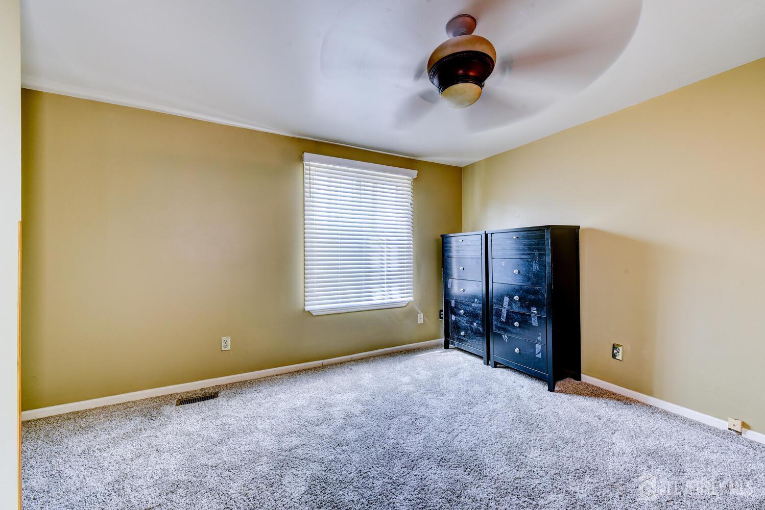 675 Bound Brook Road, Unit C0016 Dunellen, NJ 08812 - Photo 31 of 39 a view of an empty room with chandelier fan and a window