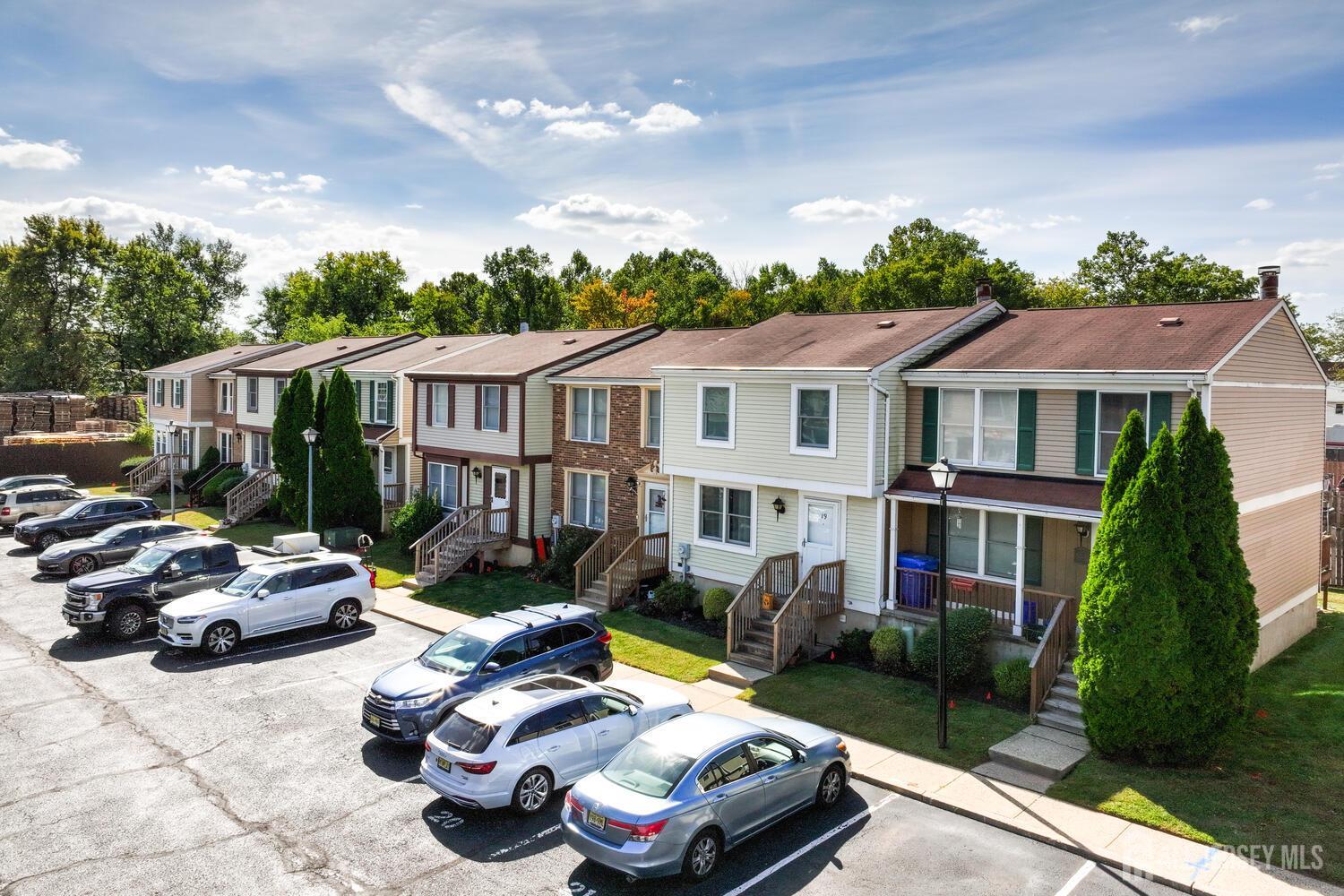 675 Bound Brook Road, Unit C0016 Dunellen, NJ 08812 - Photo 5 of 39 a car parked in front of a brick house