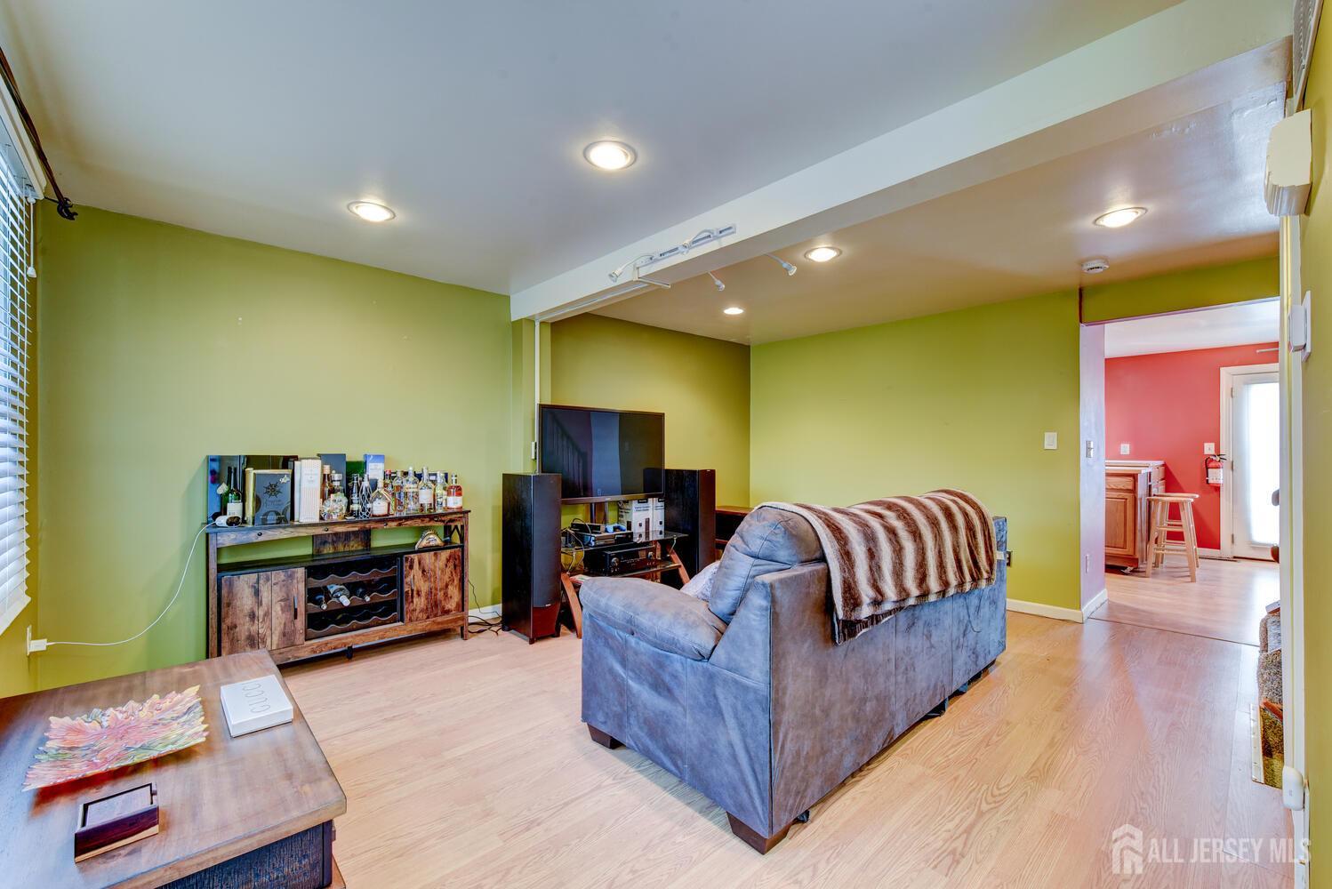 675 Bound Brook Road, Unit C0016 Dunellen, NJ 08812 - Photo 7 of 39 a living room with furniture and a flat screen tv