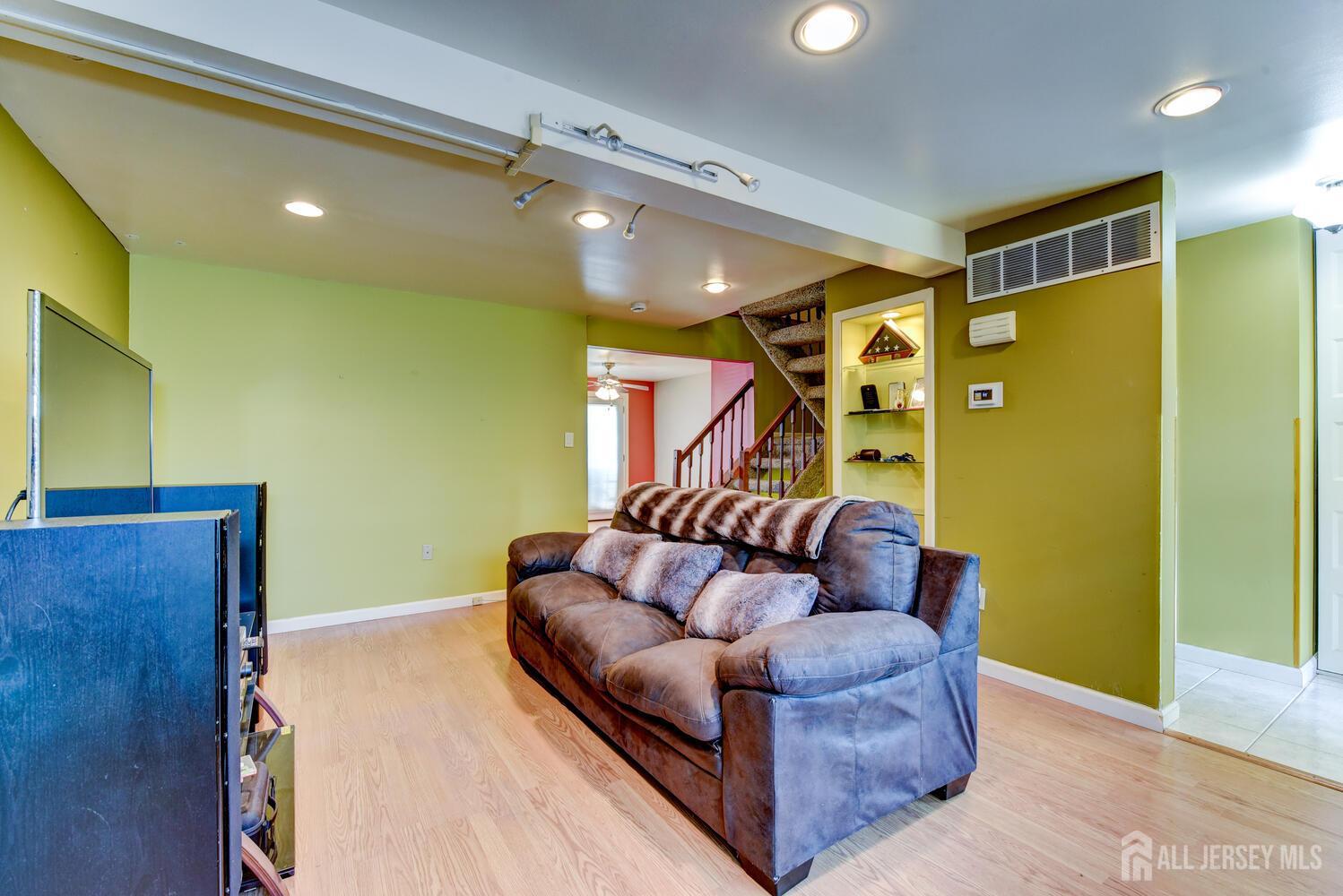 675 Bound Brook Road, Unit C0016 Dunellen, NJ 08812 - Photo 9 of 39 a living room with furniture and a wooden floor
