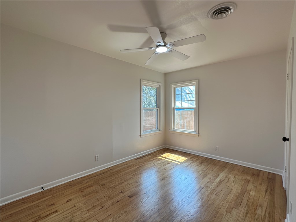 4037 Barnes Street Corpus Christi, TX 78411 - Photo 6 of 11 a view of an empty room with wooden floor and a window