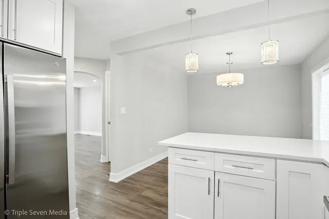 a view white cabinets with wooden floor