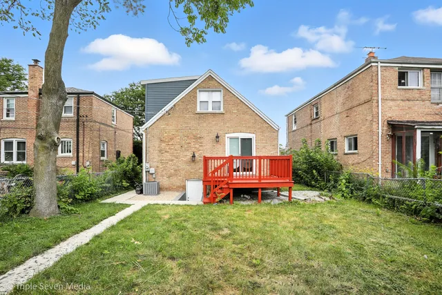 a view of a house with a yard and furniture