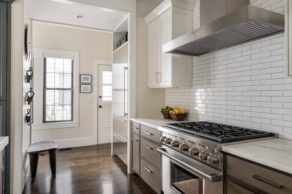 39 Meacham Road, Unit 39 Somerville, MA 02144 - Photo 14 of 40 a kitchen with wooden cabinets and a stove top oven