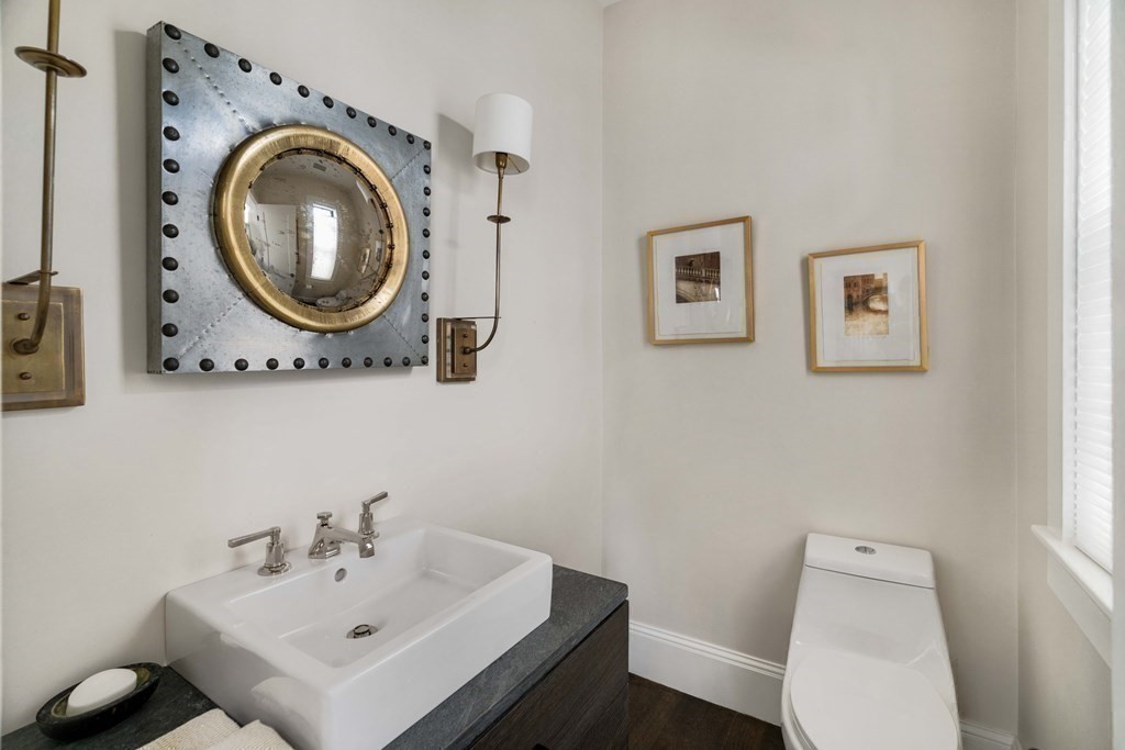 39 Meacham Road, Unit 39 Somerville, MA 02144 - Photo 15 of 40 a bathroom with a sink mirror and toilet