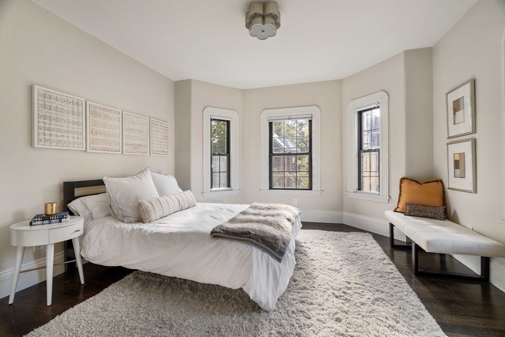 39 Meacham Road, Unit 39 Somerville, MA 02144 - Photo 19 of 40 a bedroom with a bed and wooden floor