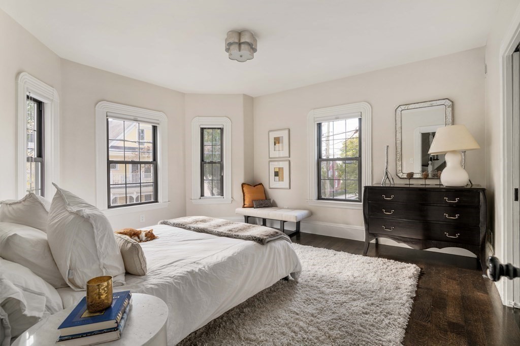 39 Meacham Road, Unit 39 Somerville, MA 02144 - Photo 20 of 40 a bedroom with a bed and wooden floor