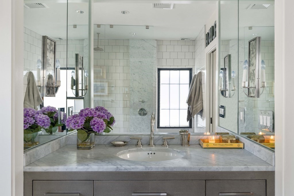 39 Meacham Road, Unit 39 Somerville, MA 02144 - Photo 22 of 40 a bathroom with a granite countertop sink a mirror and a shower