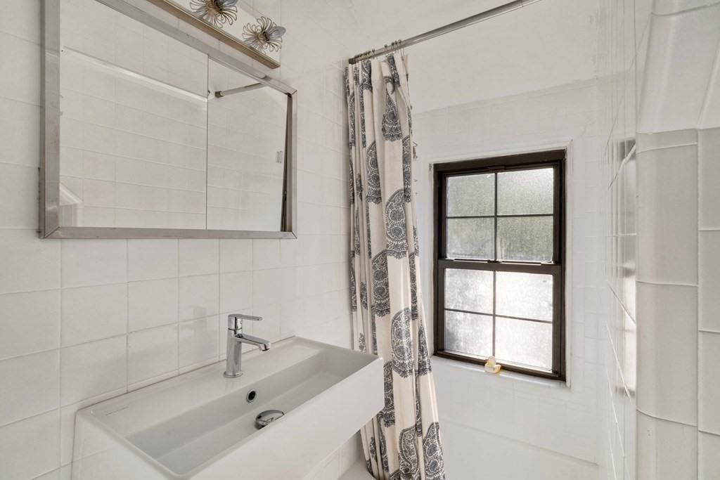 39 Meacham Road, Unit 39 Somerville, MA 02144 - Photo 32 of 40 a bathroom with a tub sink and a window