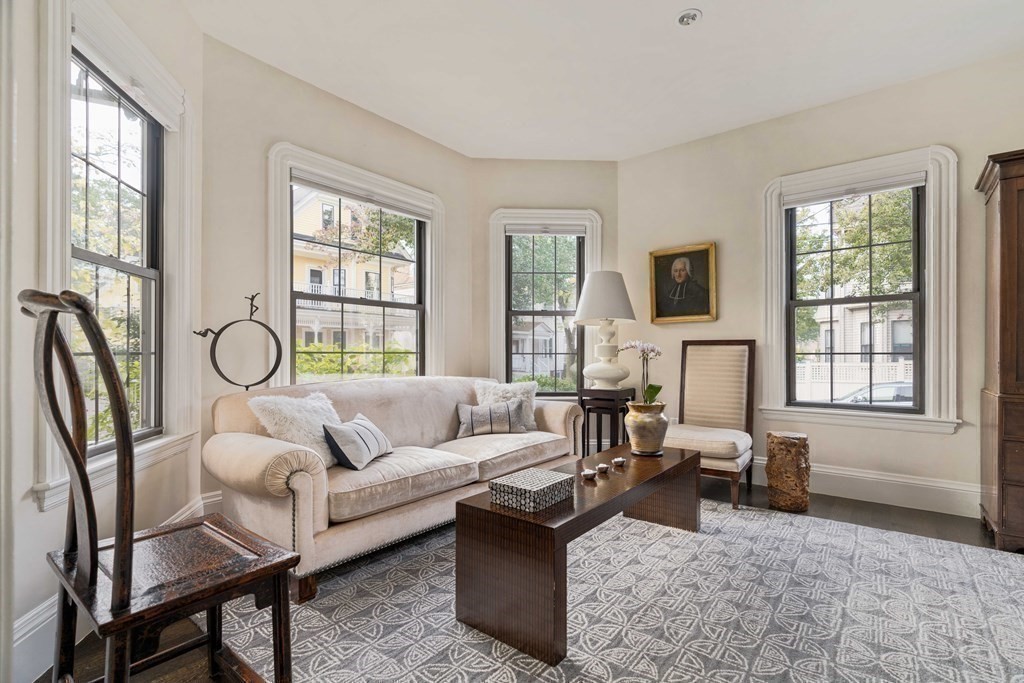 39 Meacham Road, Unit 39 Somerville, MA 02144 - Photo 4 of 40 a living room with furniture a fireplace and a large window