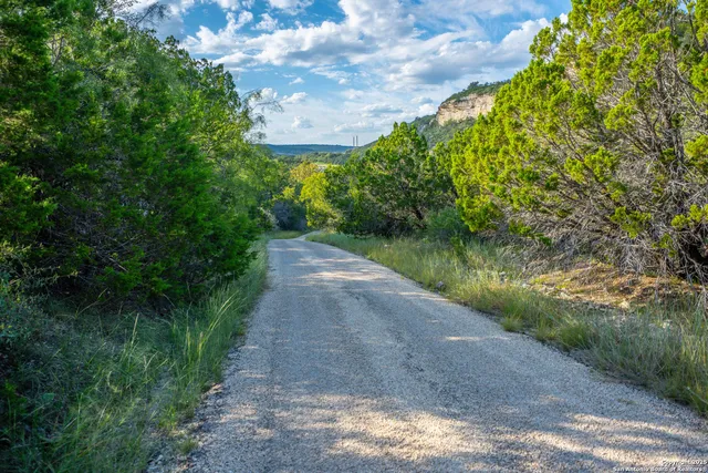 a kitchen with granite countertop a refrigerator stove and microwave