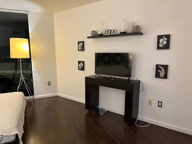 a room with wooden floor and a fireplace