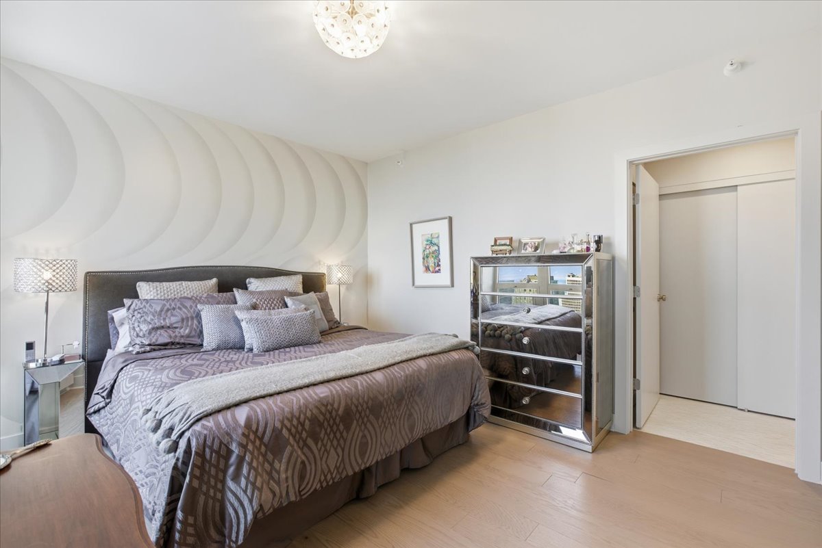 57 East Delaware Place, Unit 3904 Chicago, IL 60611 - Photo 11 of 21 a bedroom with a bed and a cabinets