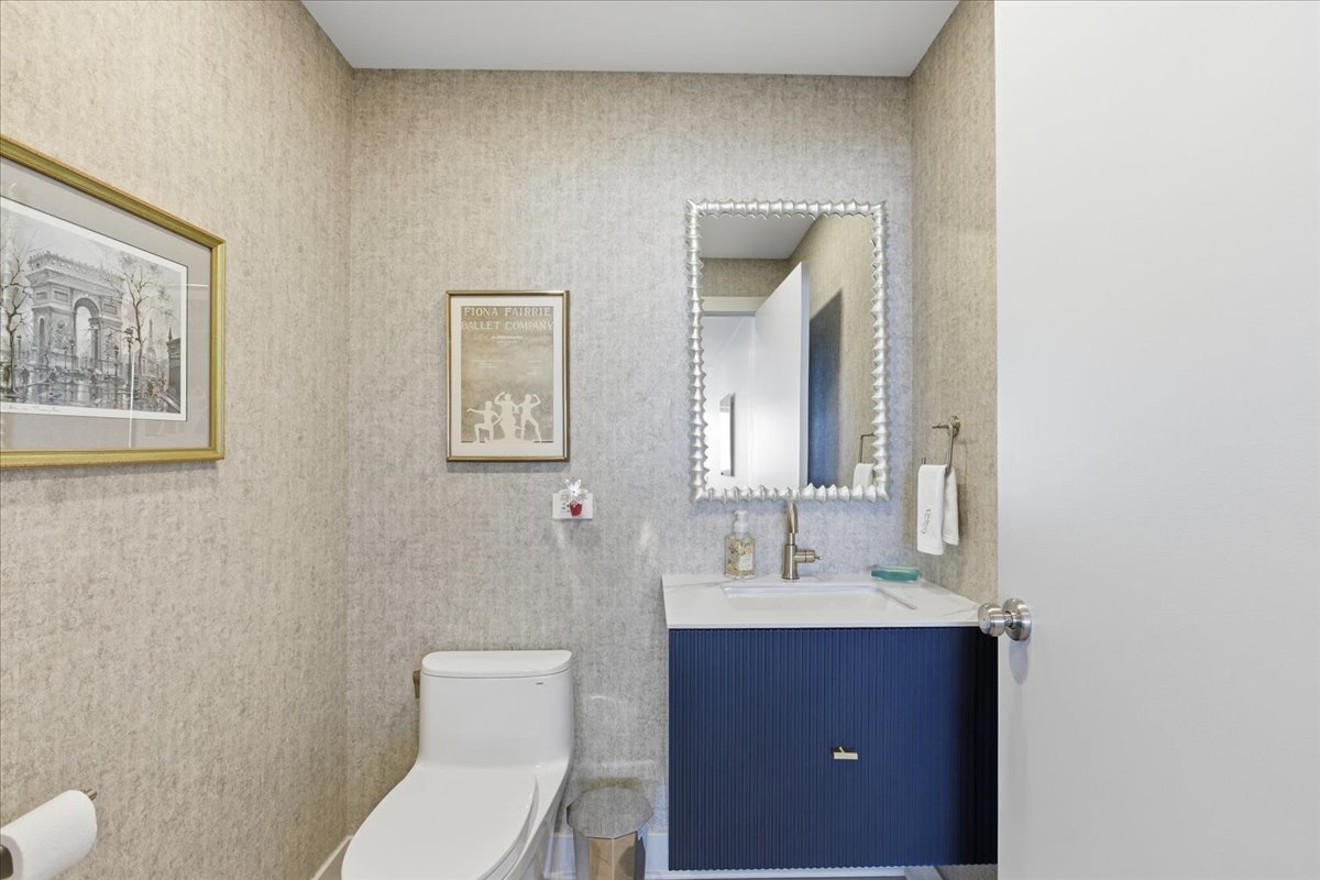 57 East Delaware Place, Unit 3904 Chicago, IL 60611 - Photo 6 of 21 a bathroom with a toilet a sink and mirror