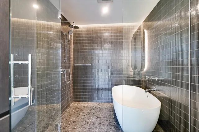 a bathroom with a bathtub and shower