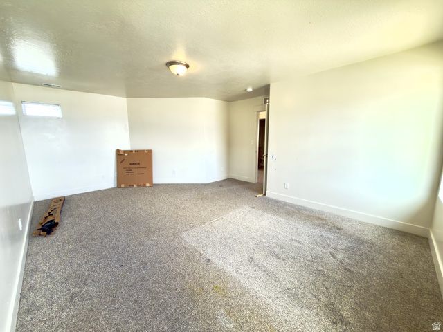 1823 South Longview Road Santaquin, UT 84655 - Photo 49 of 69 Expansive room featuring light-toned walls, a neutral carpeted floor, and a semi-flush mount ceiling light fixture