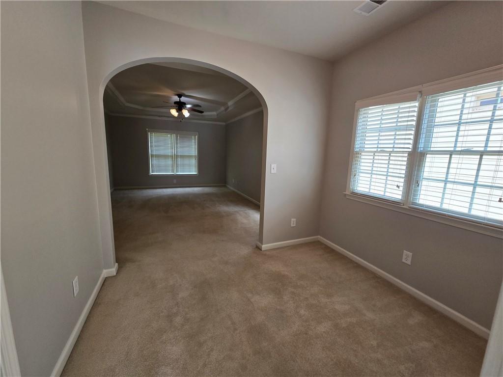 624 Maple Grove Way Marietta, GA 30066 - Photo 12 of 27 an empty room with a fireplace and windows