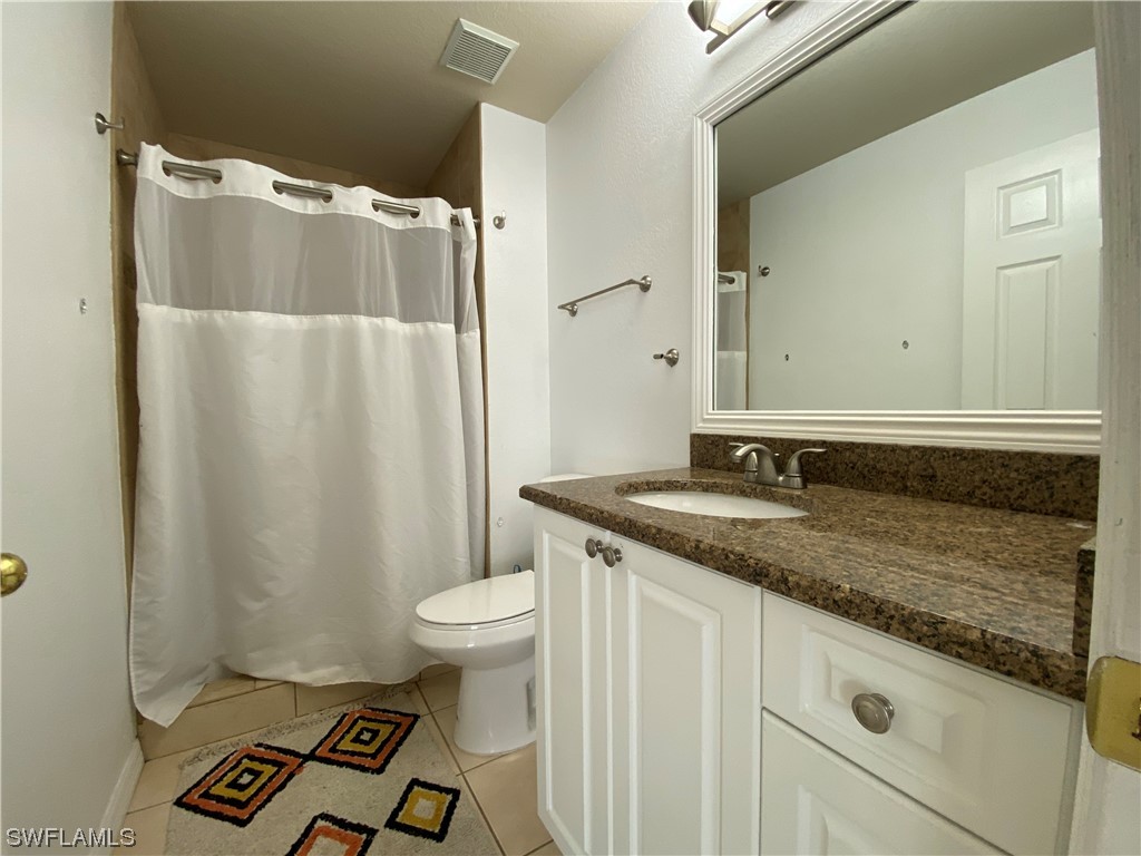 17146 Oriole Road Fort Myers, FL 33967 - Photo 12 of 38 a bathroom with a granite countertop sink and a mirror