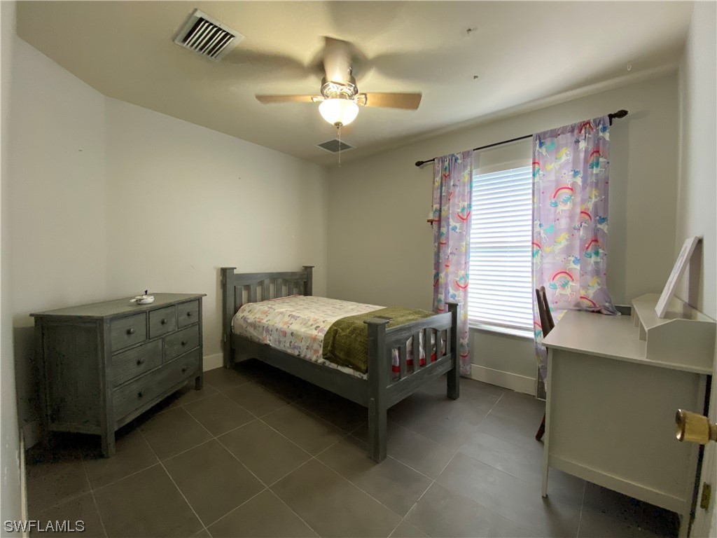 17146 Oriole Road Fort Myers, FL 33967 - Photo 27 of 38 a bedroom with a bed and a desk