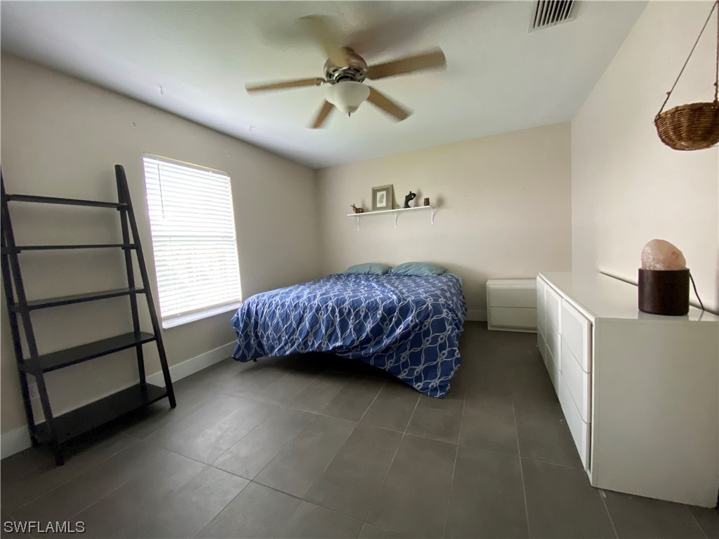 17146 Oriole Road Fort Myers, FL 33967 - Photo 32 of 38 a bedroom with a bed and a window