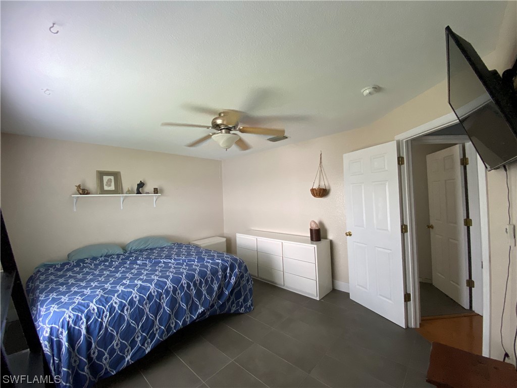 17146 Oriole Road Fort Myers, FL 33967 - Photo 33 of 38 a bedroom with a bed and a chandelier