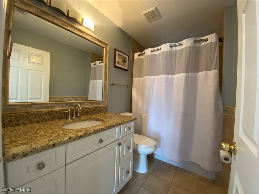 17146 Oriole Road Fort Myers, FL 33967 - Photo 34 of 38 a bathroom with a granite countertop sink toilet and shower