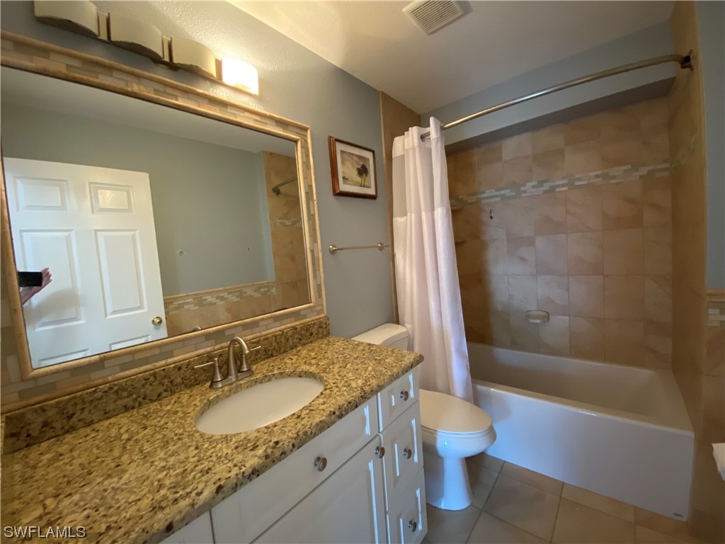 17146 Oriole Road Fort Myers, FL 33967 - Photo 35 of 38 a bathroom with a granite countertop sink toilet and shower